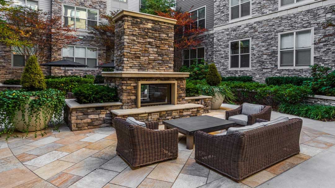 outdoor lounge with stone fireplace